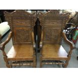 A pair of Oak open Arm chairs with carved backs an