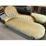 A walnut Chaise Lounge with a shaped back and scro