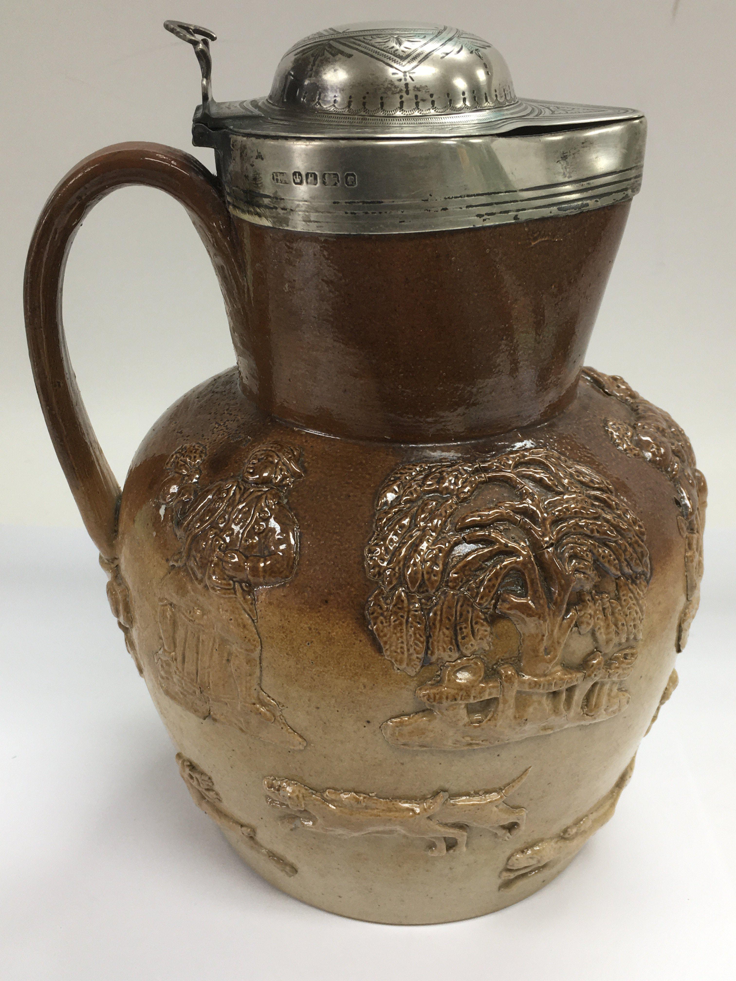 A silver lidded Harvestware jug, possibly Doulton