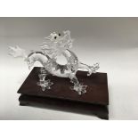 A Swarovski dragon on a wooden stand (2)