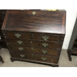 A Georgian mahogany bureau the fall front above two short and three long drawers on bracket feet .