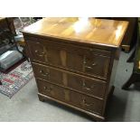 A Yew wood chest of drawers with a brushing slide