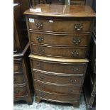 A walnut bow fronted chest on chest Fitted with se