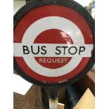 A enamel and cast iron bus stop sign.