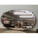 A large peach coloured glass mirror, 68 x38.