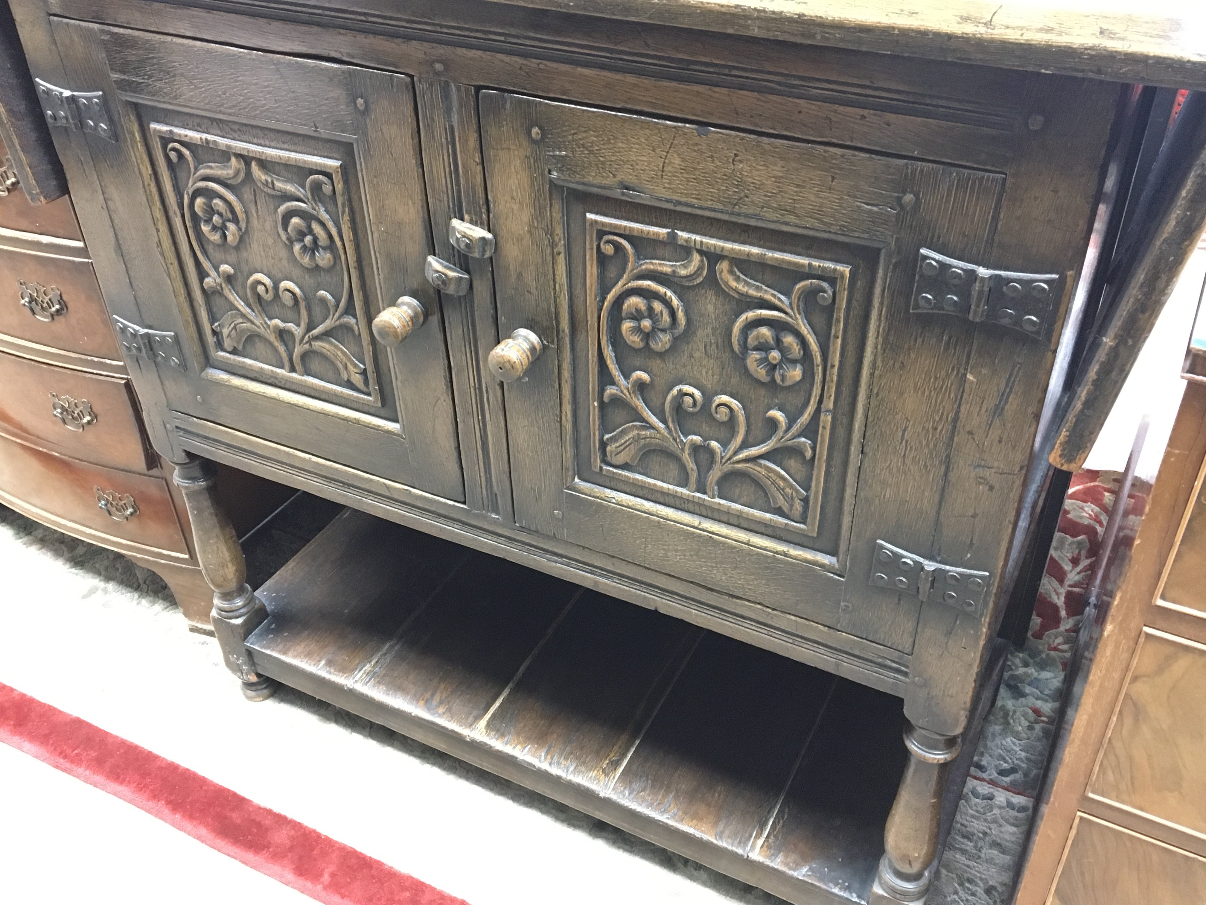 A carved oak cupboard the top with a drop flap abo - Image 2 of 2