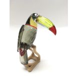 A Swarovski diamond in the shape of a Toucan on a