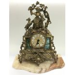A brass ormolu mantle clock decorated with the fig