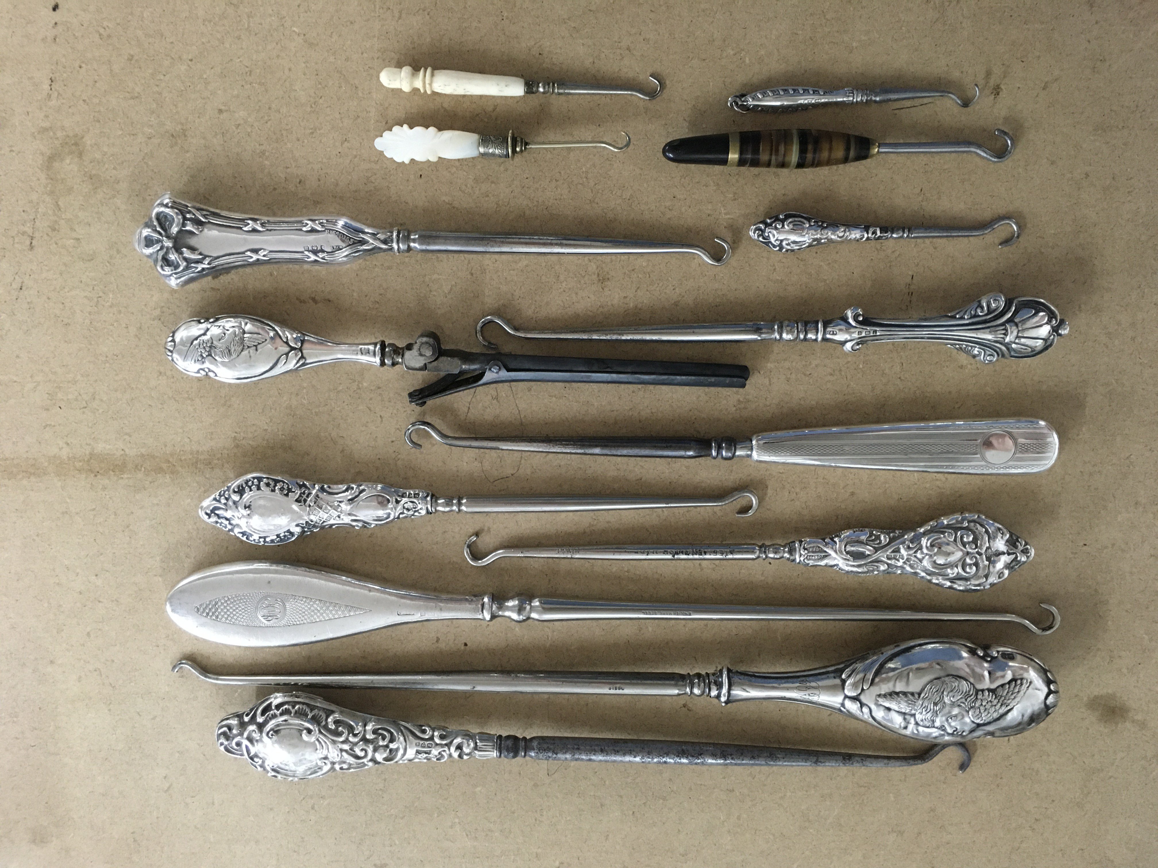 A collection of silver handled button hooks etc.