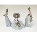 Three Lladro figures in the form of ladies.Two hol