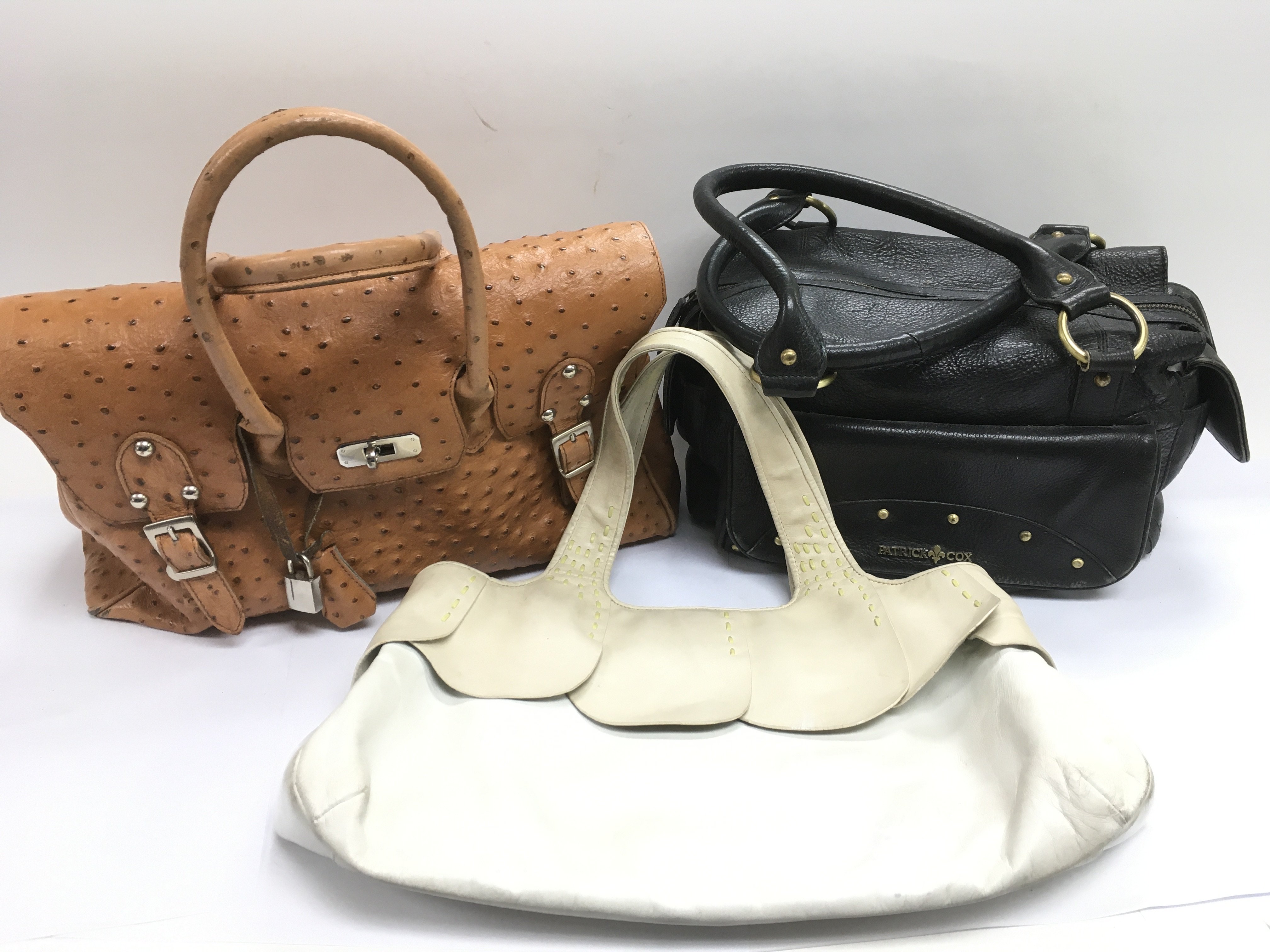 Three designer handbags including Radley, Patrick