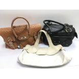 Three designer handbags including Radley, Patrick