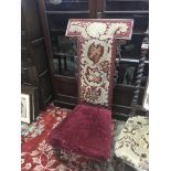 A Victorian walnut prayer chair with needlepoint upholstered back