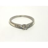 A 9ct white gold solitaire diamond ring with furth