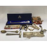 A bag containing watches, a pearl bracelet, a 75 series Matchbox die cast car and other items.
