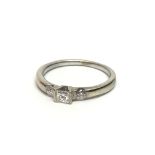 An 18ct white gold three stone diamond ring set wi