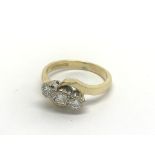An 18ct gold three stone diamond ring, approx .25c