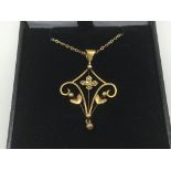 A 9ct gold Art Nouveau pendant on a 9ct gold chain