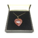 A Cornelian heart shaped pendant on a 9ct gold cha