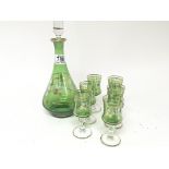 A painted green glass liquor set with decanter and