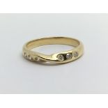 An 18ct gold ring set with six small diamonds, app