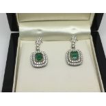 A boxed pair of 18ct white gold emerald and diamon