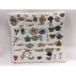 A collection of approx 50 brooches presented on a