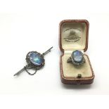 A silver opal ring and a similar opal brooch (2).