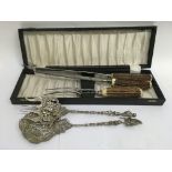 A cased three piece horn carving set and a pair of