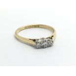 An 18carat gold ring set with three diamonds ring