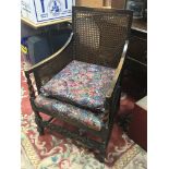 A burgere chair with cane back and sides with barl