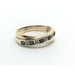 A 9carat gold ring set with alternating diamond an