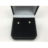 A pair of 14ct diamond ear studs, approx 25 points
