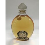 A large bottle of De Guerlian of Paris perfume.