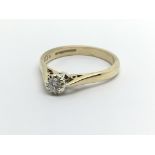 A 9carat gold ring set with a solitaire diamond ap