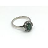 An unmarked emerald and diamond ring, approx 3.3g