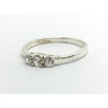 A 9ct white gold three stone diamond ring, approx