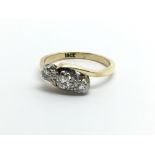 An 18ct gold three stone diamond ring, approx 2.8g