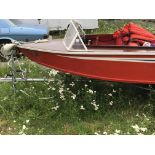 An in shore boat The Cockney Rebel II with rear and front bench seats set up for an outboard engine.