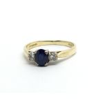 An 18ct gold ring set with a sapphire and two diam