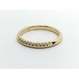 An 18ct gold half eternity diamond ring, approx 3g