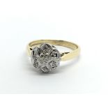 An 18ct gold seven stone diamond ring in a flowerh