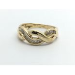 An 18ct gold twelve stone diamond twist ring, appr