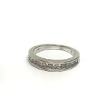 A 9ct white gold twelve stone half eternity ring,