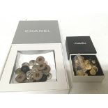 Two boxes of authentic Chanel buttons various desi