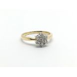 An 18carat gold ring set with a floral pattern of