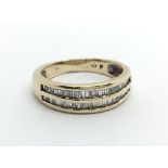 A 9ct gold ring set with two rows of baguette cut