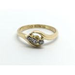 An 18ct gold three stone ten point diamond ring, a