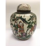 A crackle ware jar with lid, decorated with warrio