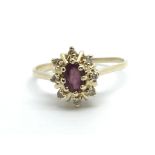 A 9ct gold ring set with a central ruby surrounded